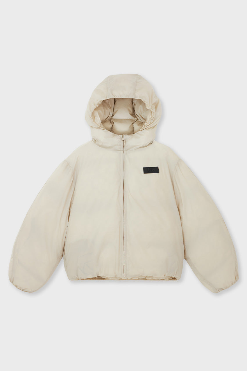 #color_stone - Front view of kids’ reversible puffer jacket in stone — made from recycled nylon and sustainably designed