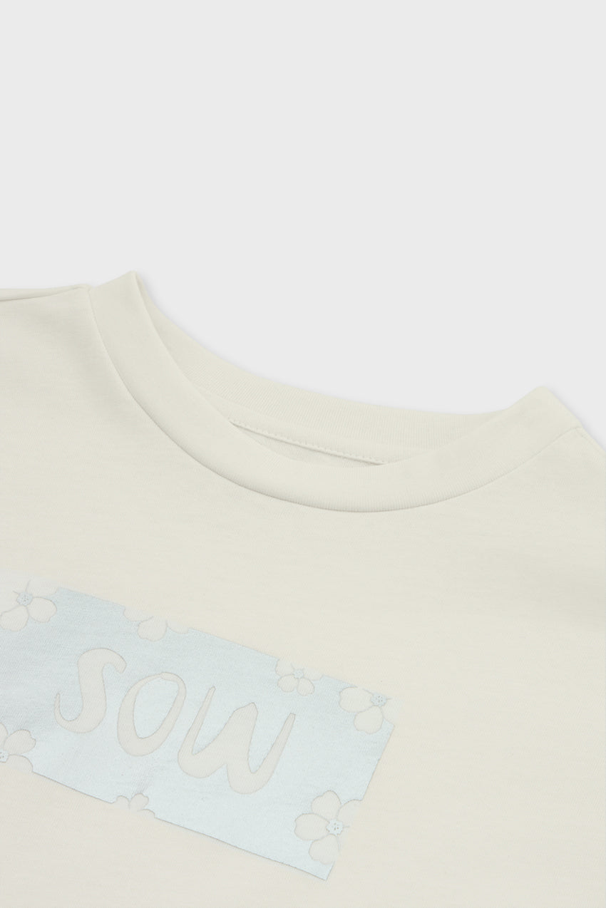 #color_off white - Close-up of SOW print on organic cotton kids tee — gentle, eco-safe inks and sustainable fabric